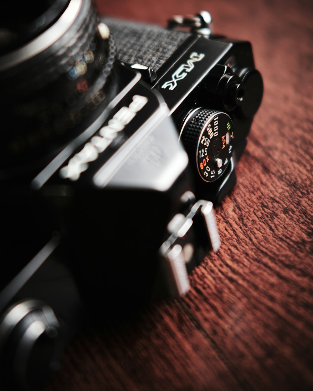 black and silver camera on brown wooden table