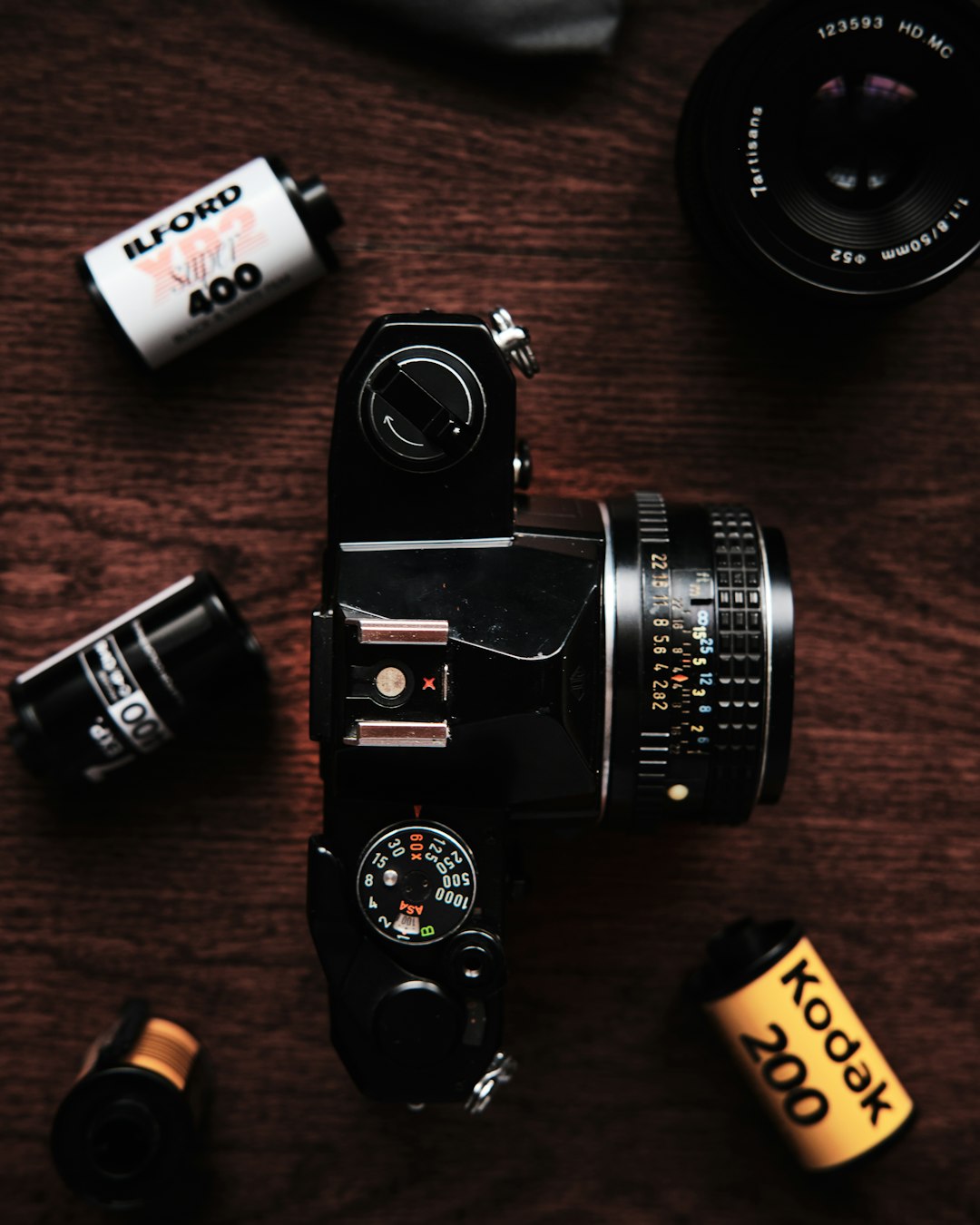 black and silver dslr camera on brown wooden table