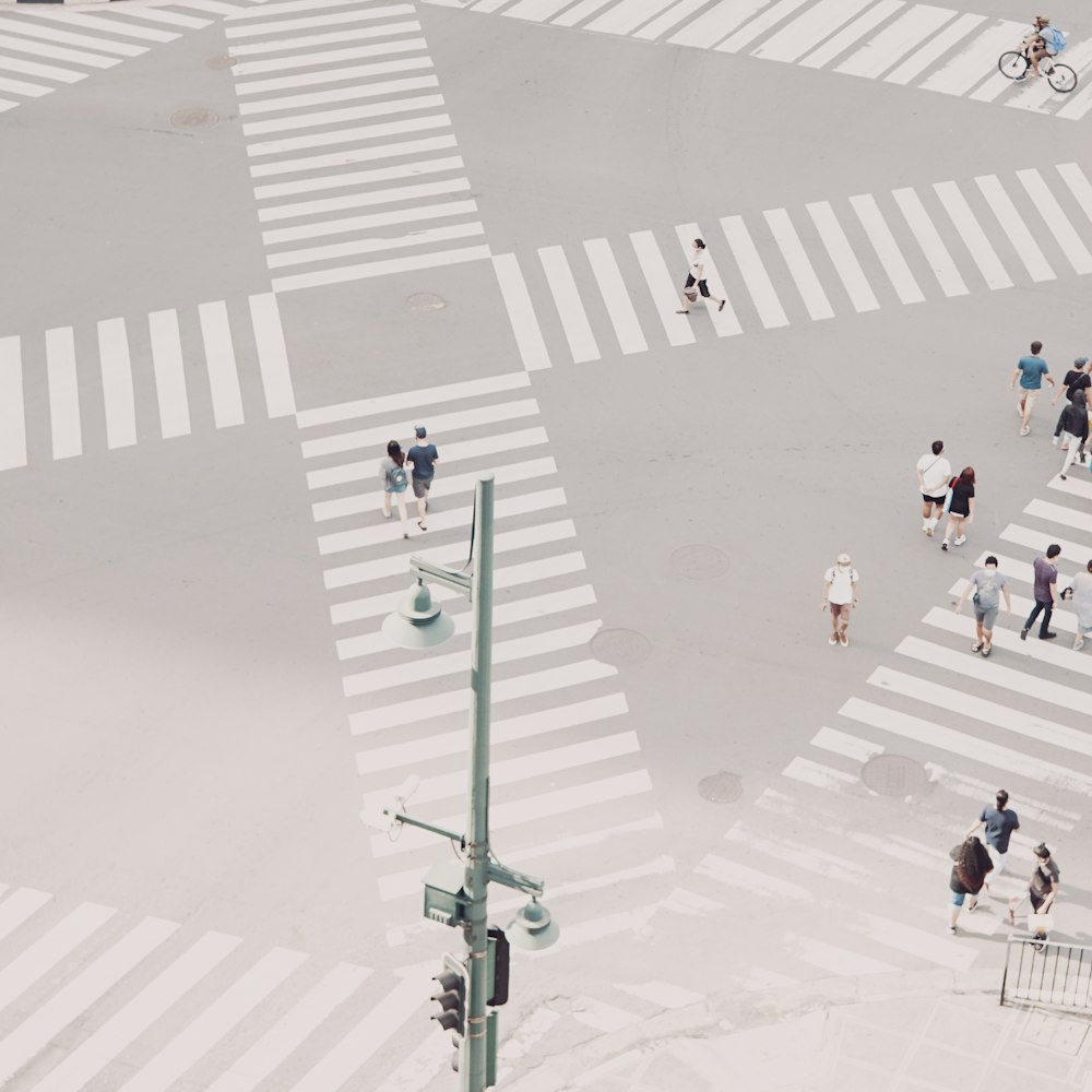 people walking on pink and white floor tiles