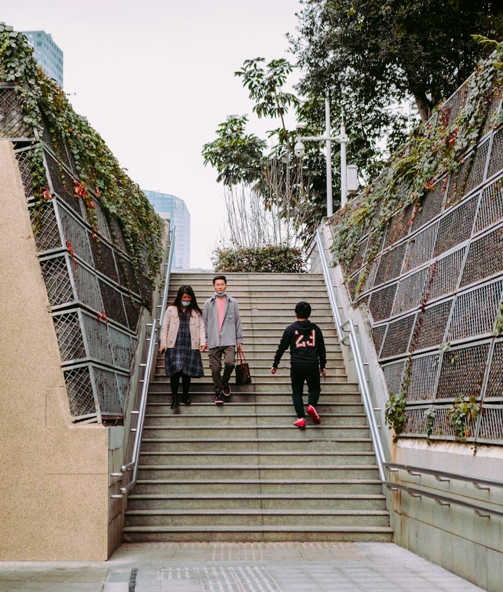 woman in black jacket walking on gray concrete stairs during daytime