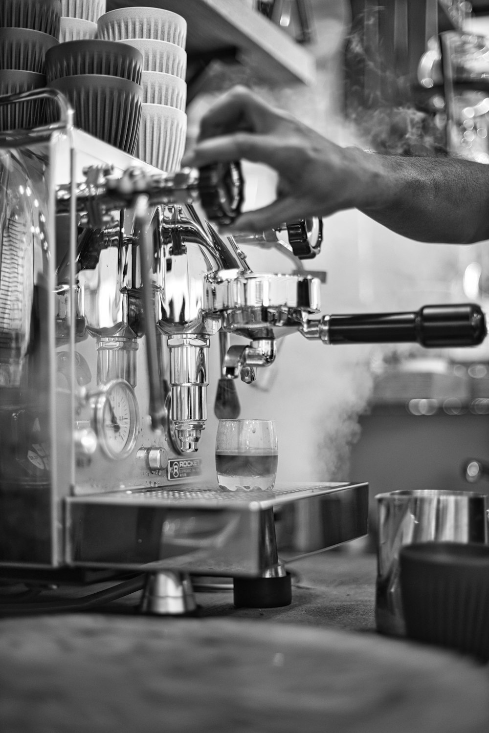 person pouring water on stainless steel cup