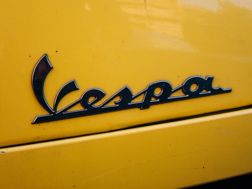 a close up of the emblem on a yellow car