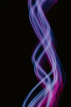 A glowing 3D neon Aries zodiac symbol spinning against a cosmic starfield background.