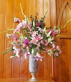 A beautifully designed floor vase filled with fresh flowers.