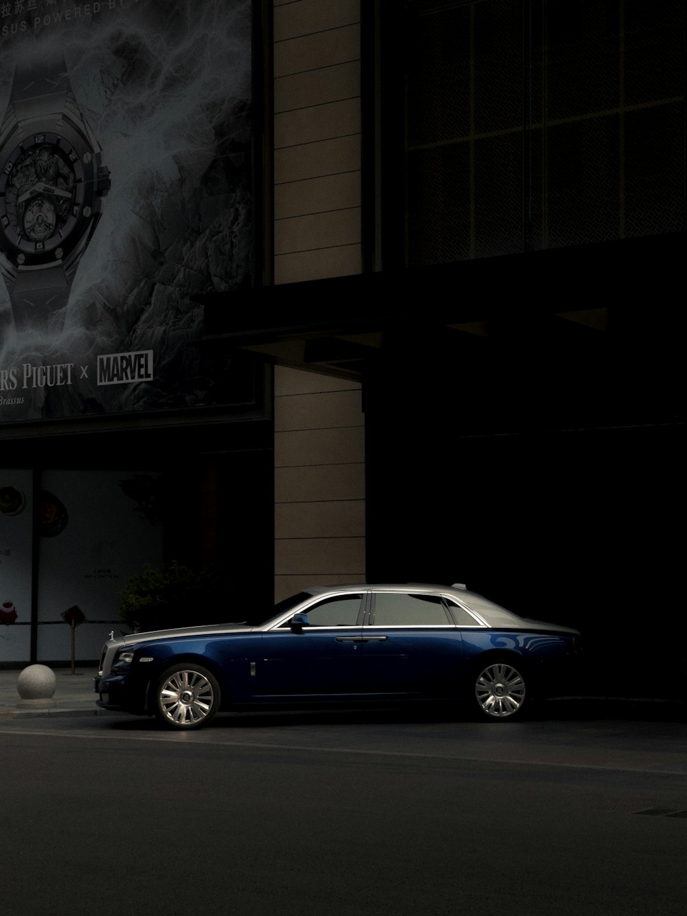 a blue car parked in front of a building