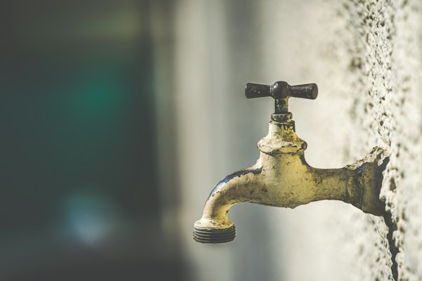 Brass faucet with water droplets