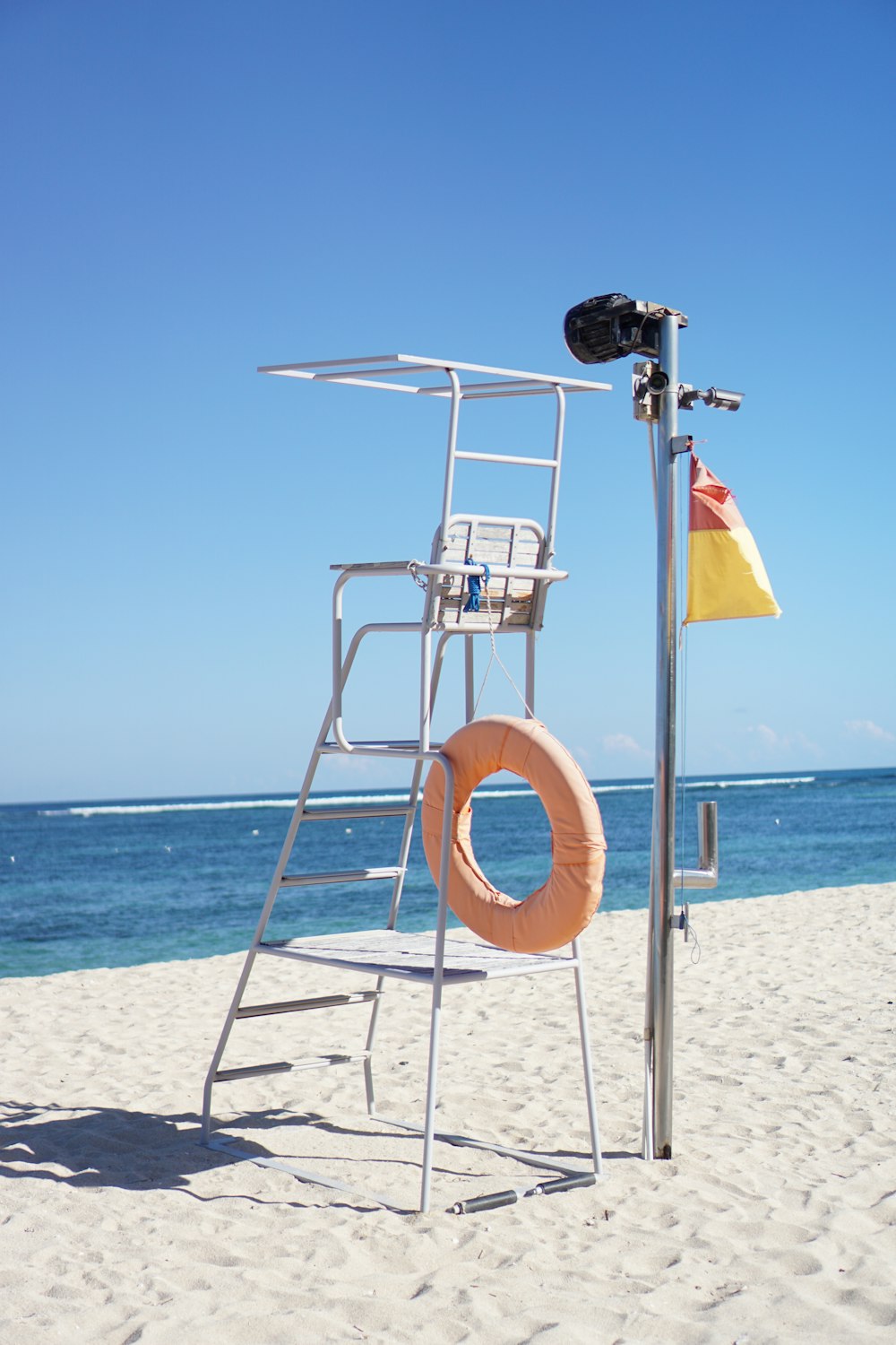 yellow and white flag on beach during daytime