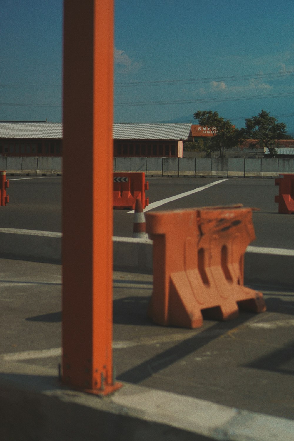 orange traffic cone on gray concrete road during daytime