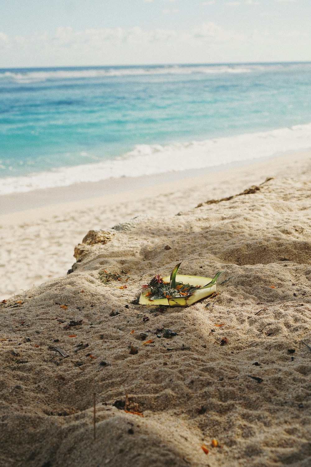 green and white plastic boat on brown sand beach during daytime