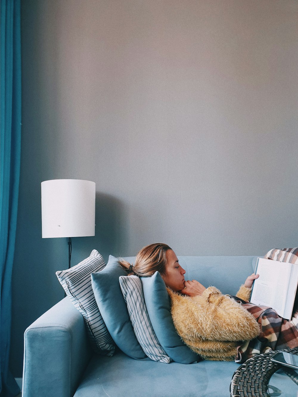 woman in white sweater lying on bed