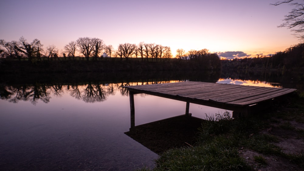 brown wooden dock on lake during daytime