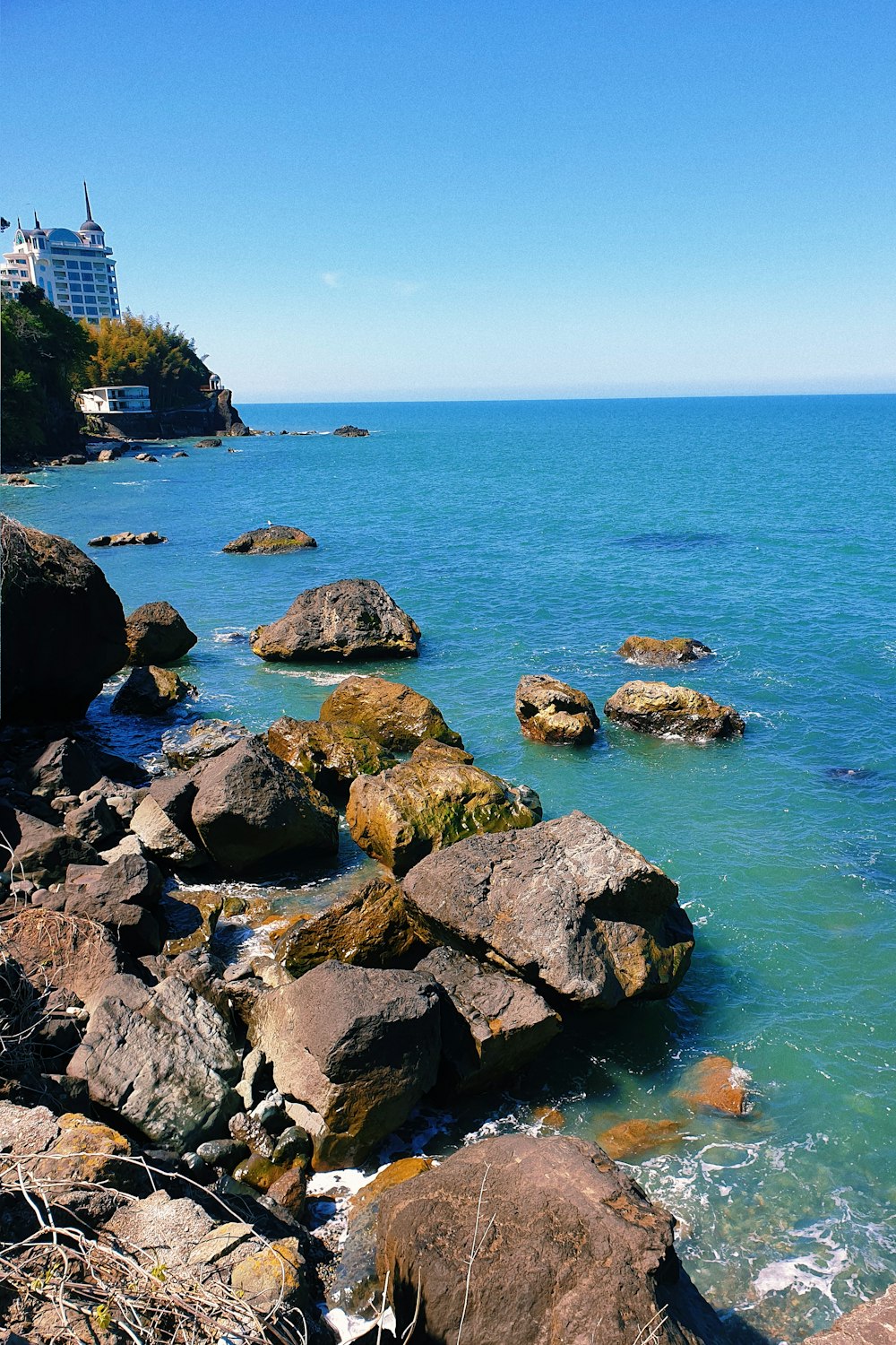 brown and gray rocks on sea shore during daytime