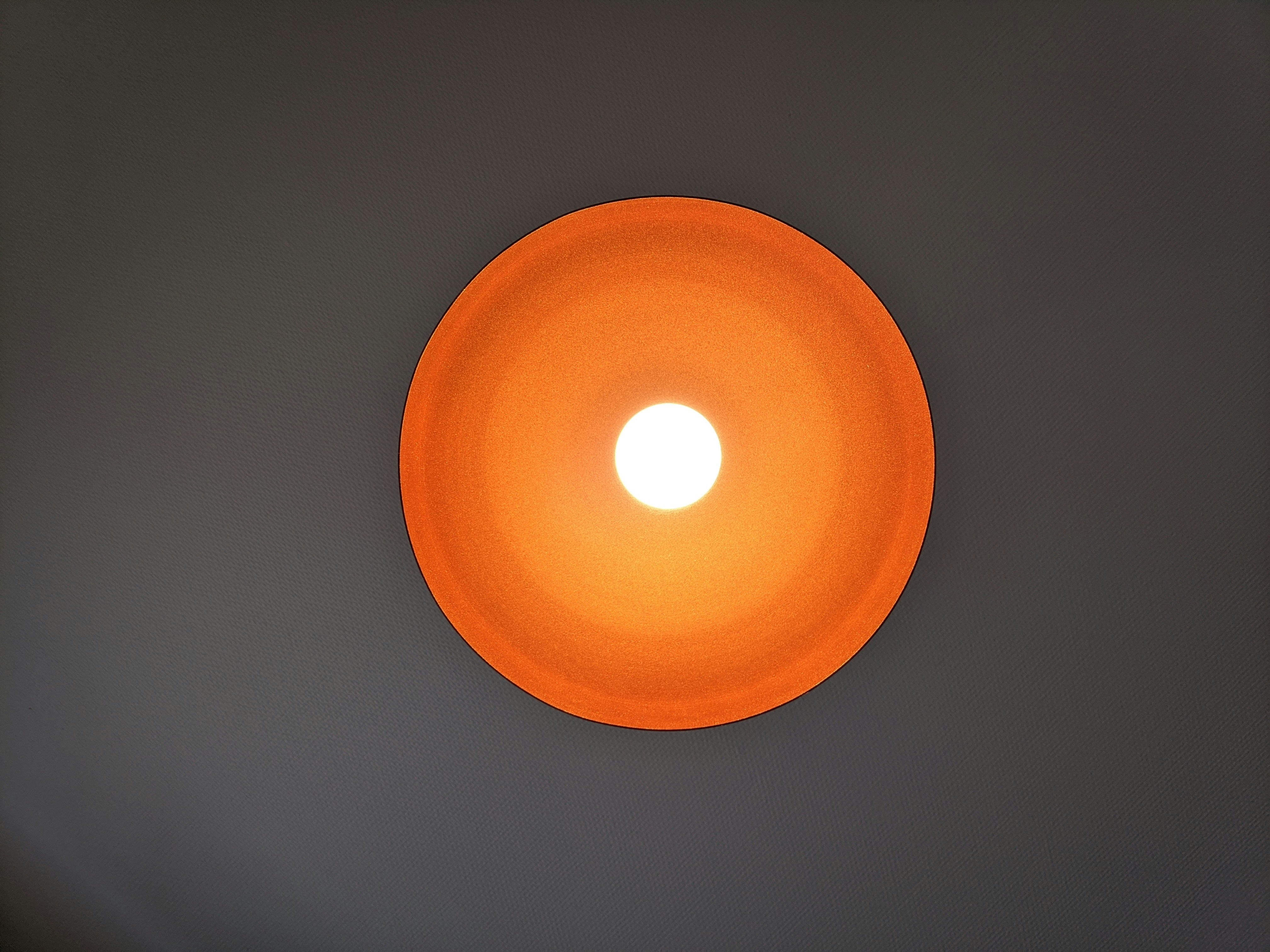 orange round light on white ceiling