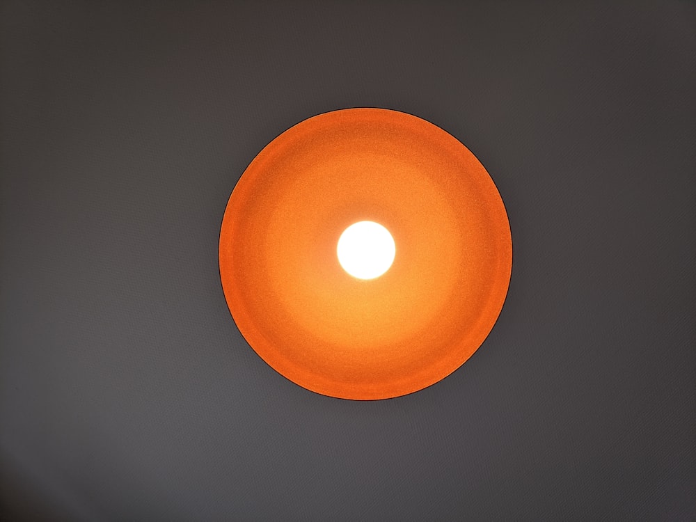 orange round light on white ceiling