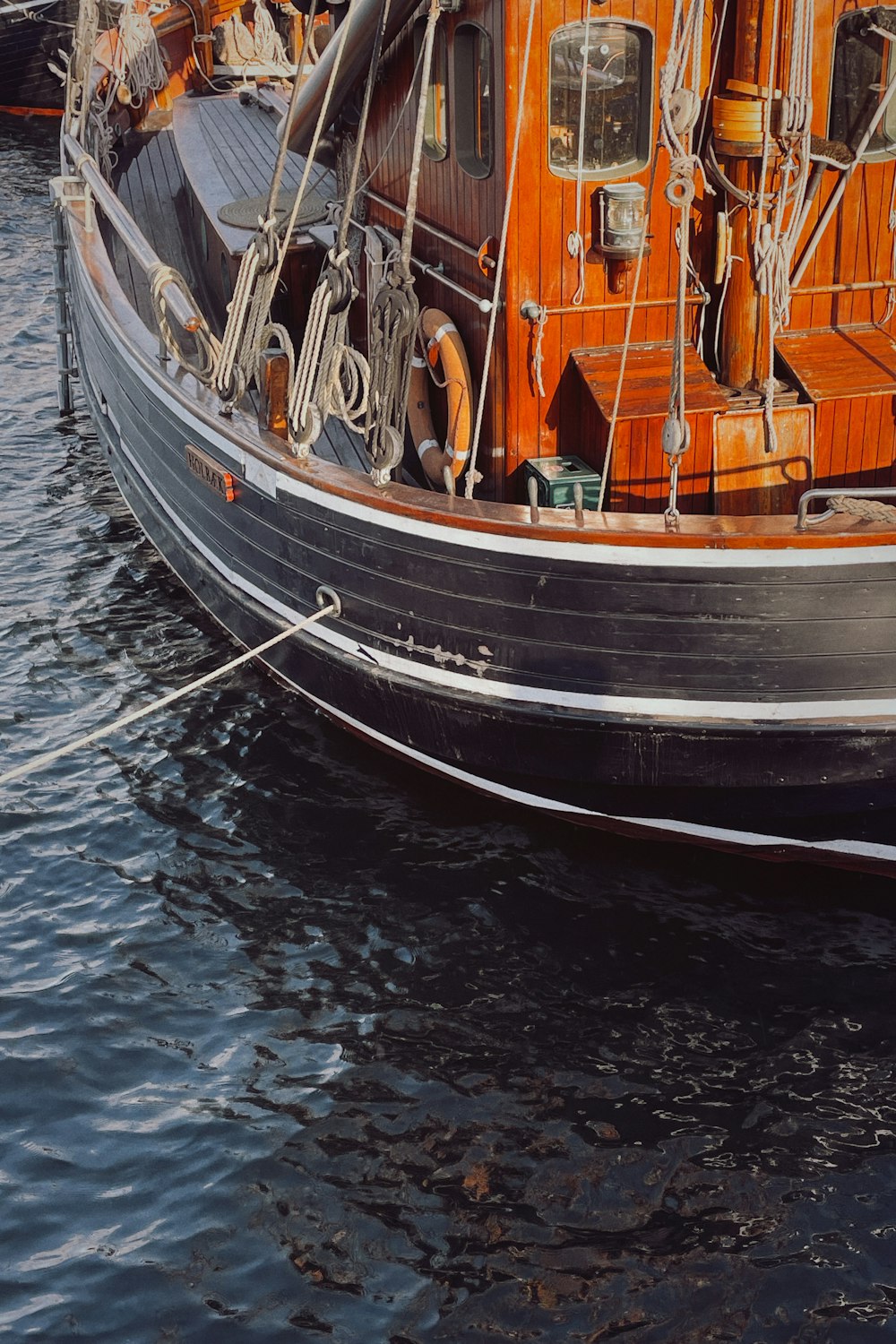 white and brown boat on body of water during daytime