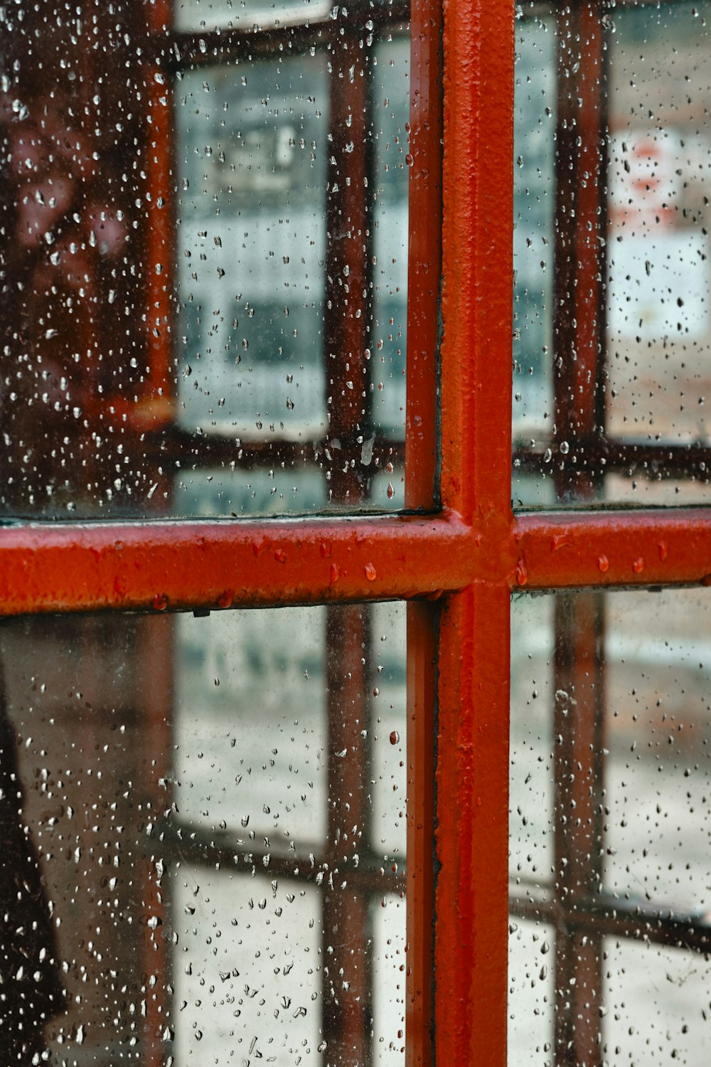 red wooden framed glass window