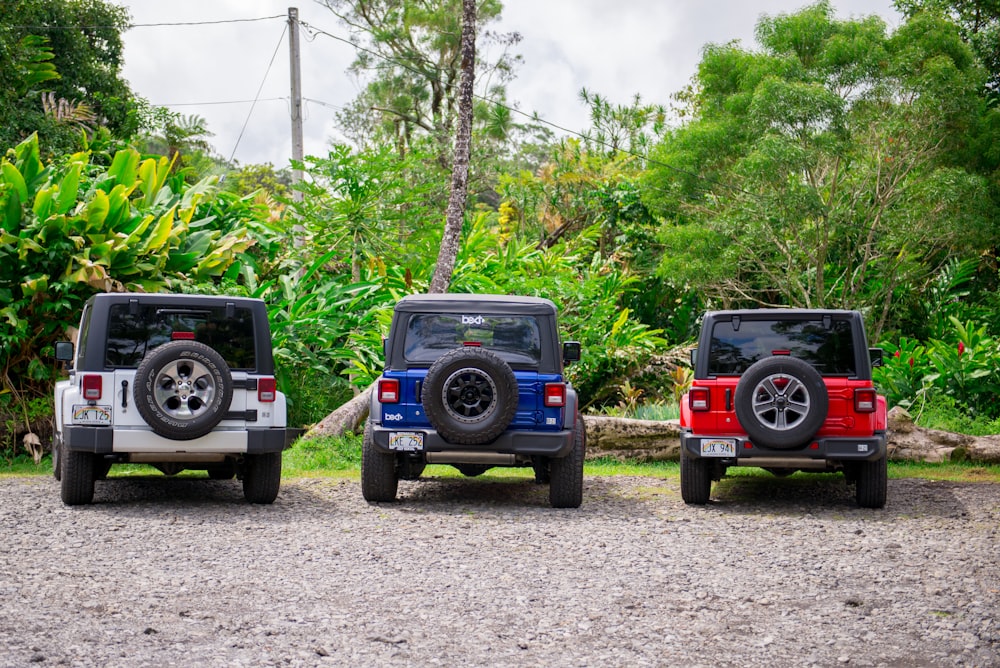 blue and white jeep wrangler on dirt road during daytime