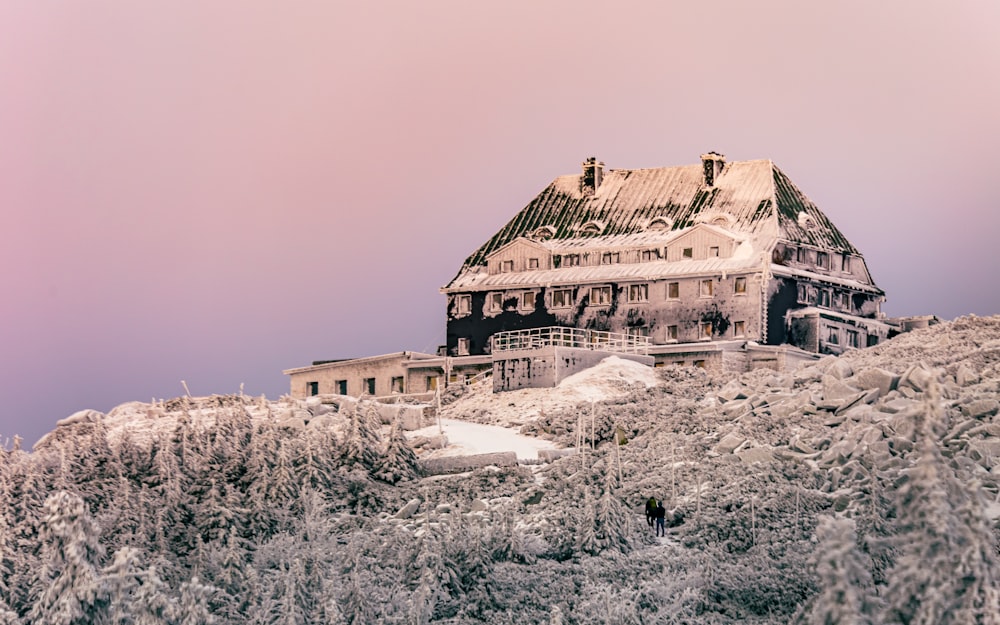 brown concrete building on snow covered ground