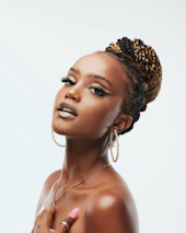 Portrait of a confident instructor with chic hairstyle and flawless makeup in a Vogue-inspired studio.