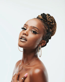 Portrait of a confident instructor with chic hairstyle and flawless makeup in a Vogue-inspired studio.