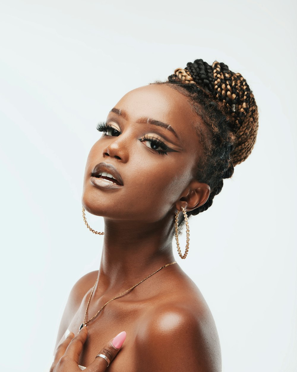 woman in white tank top wearing gold crown