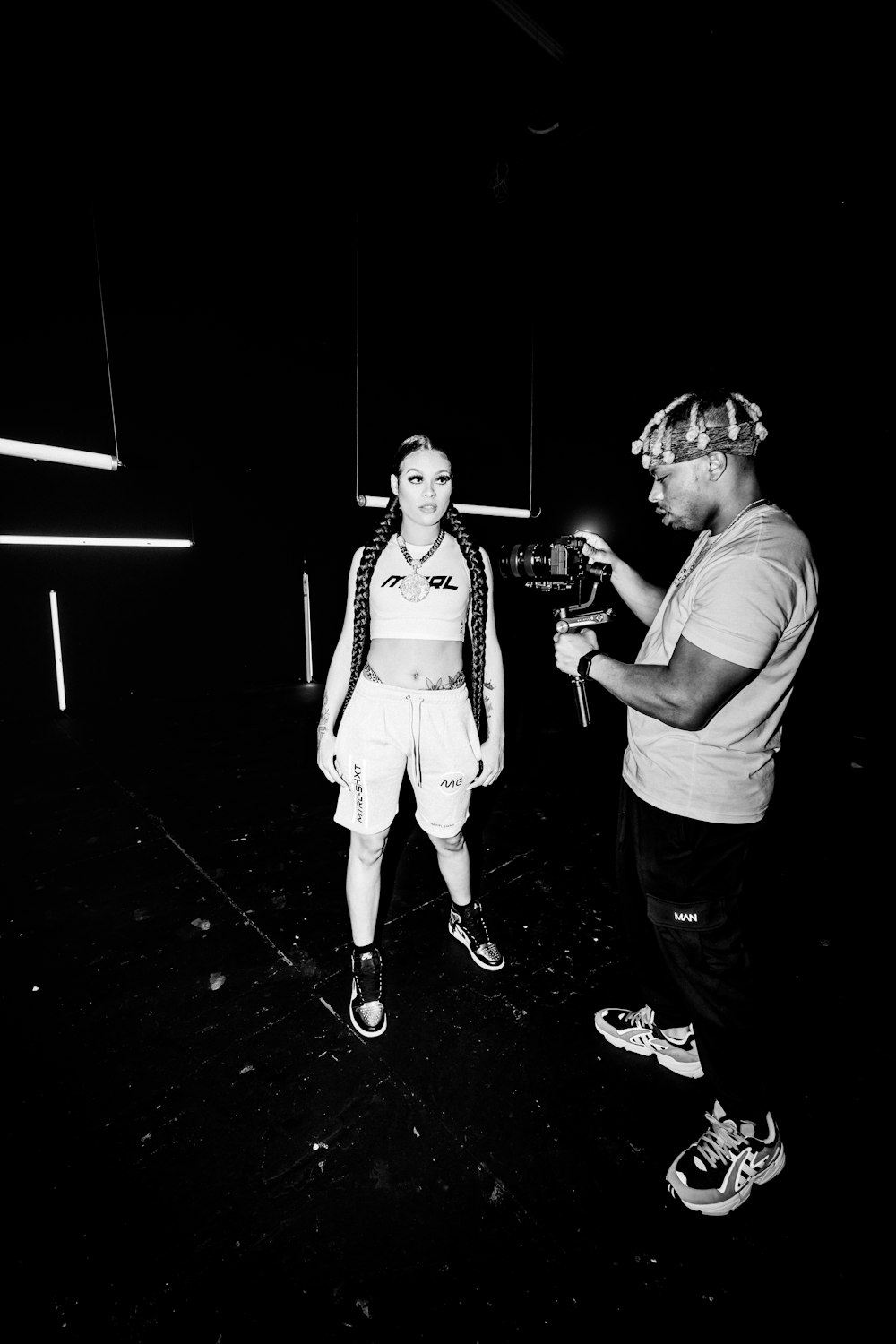 man and woman standing beside each other in grayscale photography