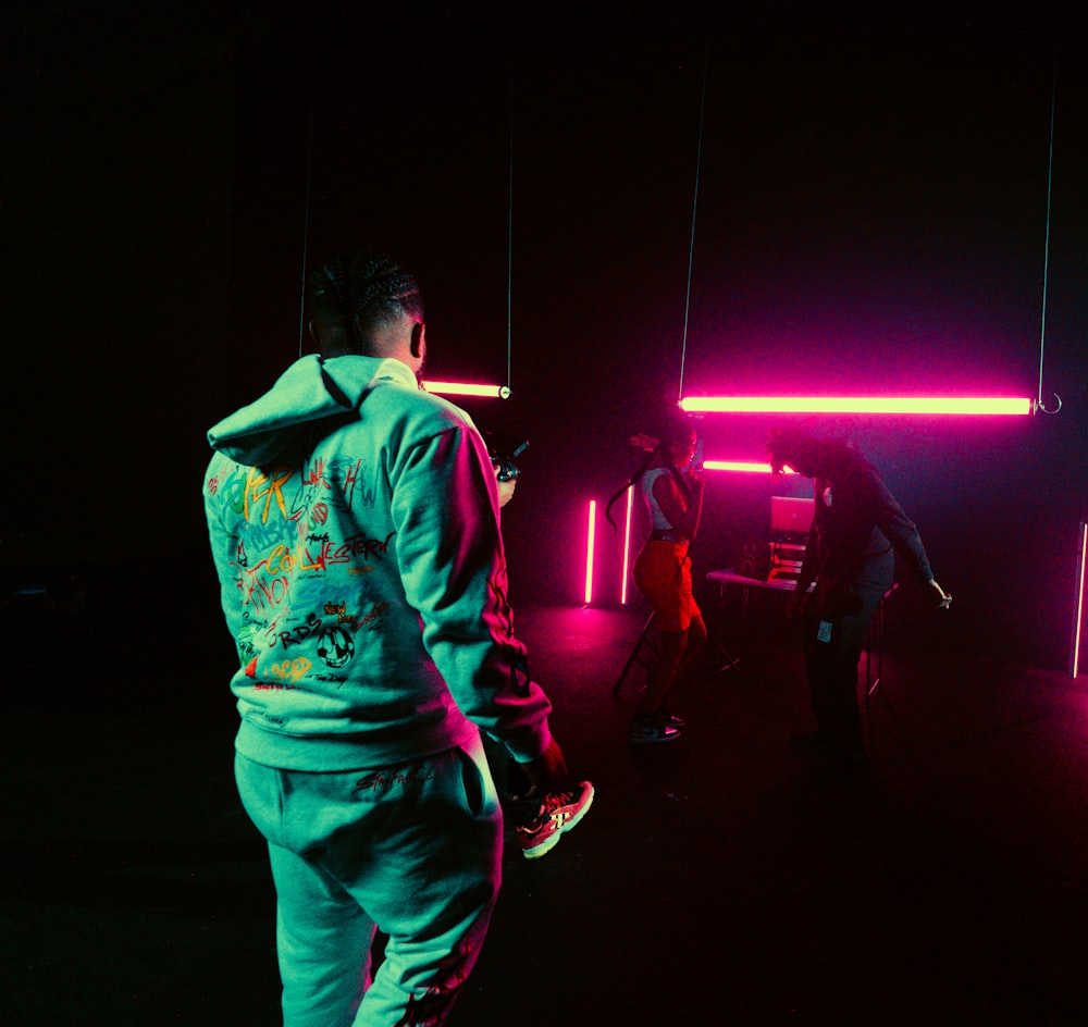 man in green and white jacket standing on stage