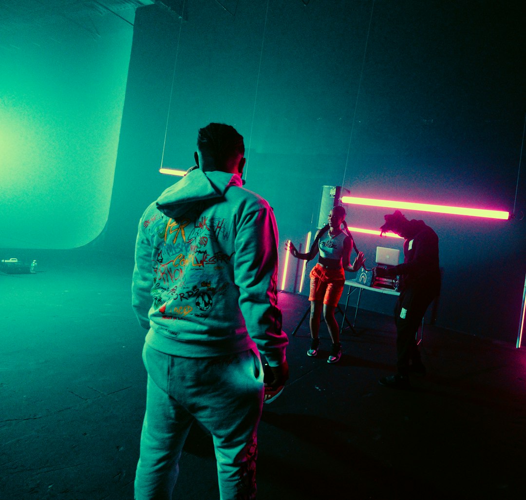 man in green and yellow jacket standing