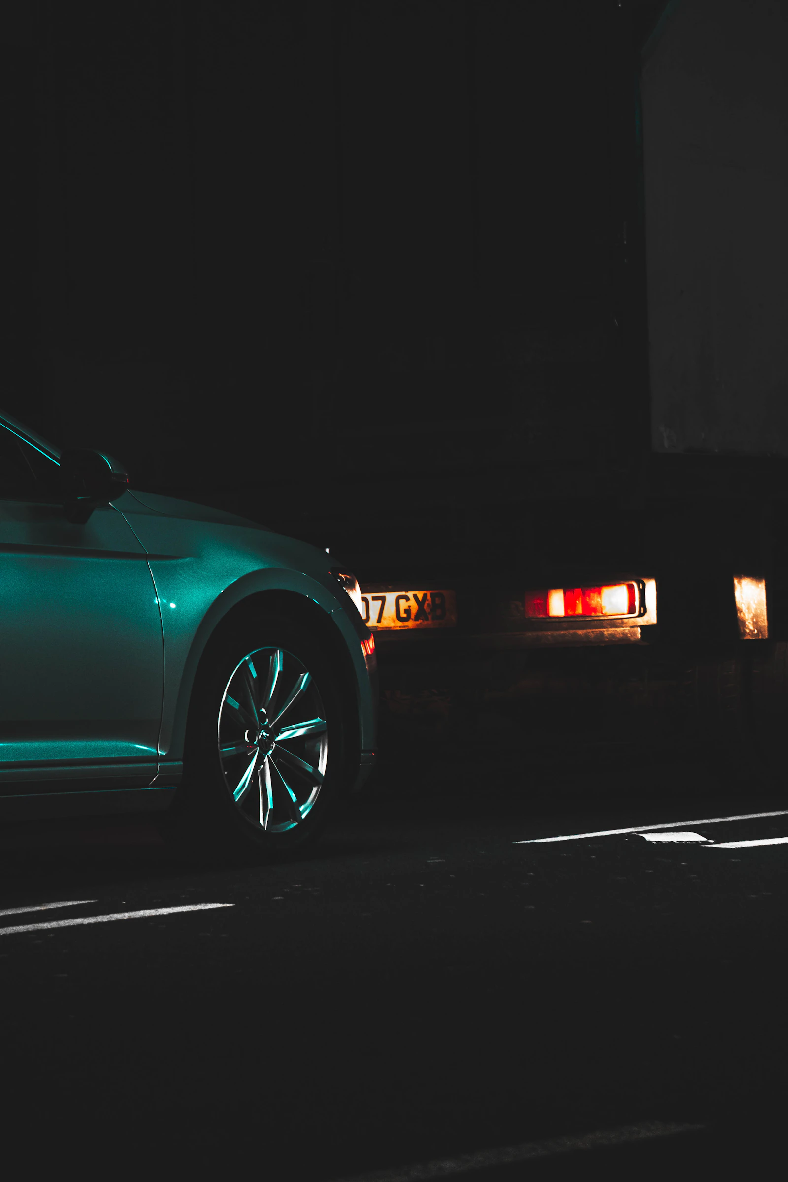 An alloy wheel lit by streetlight at night