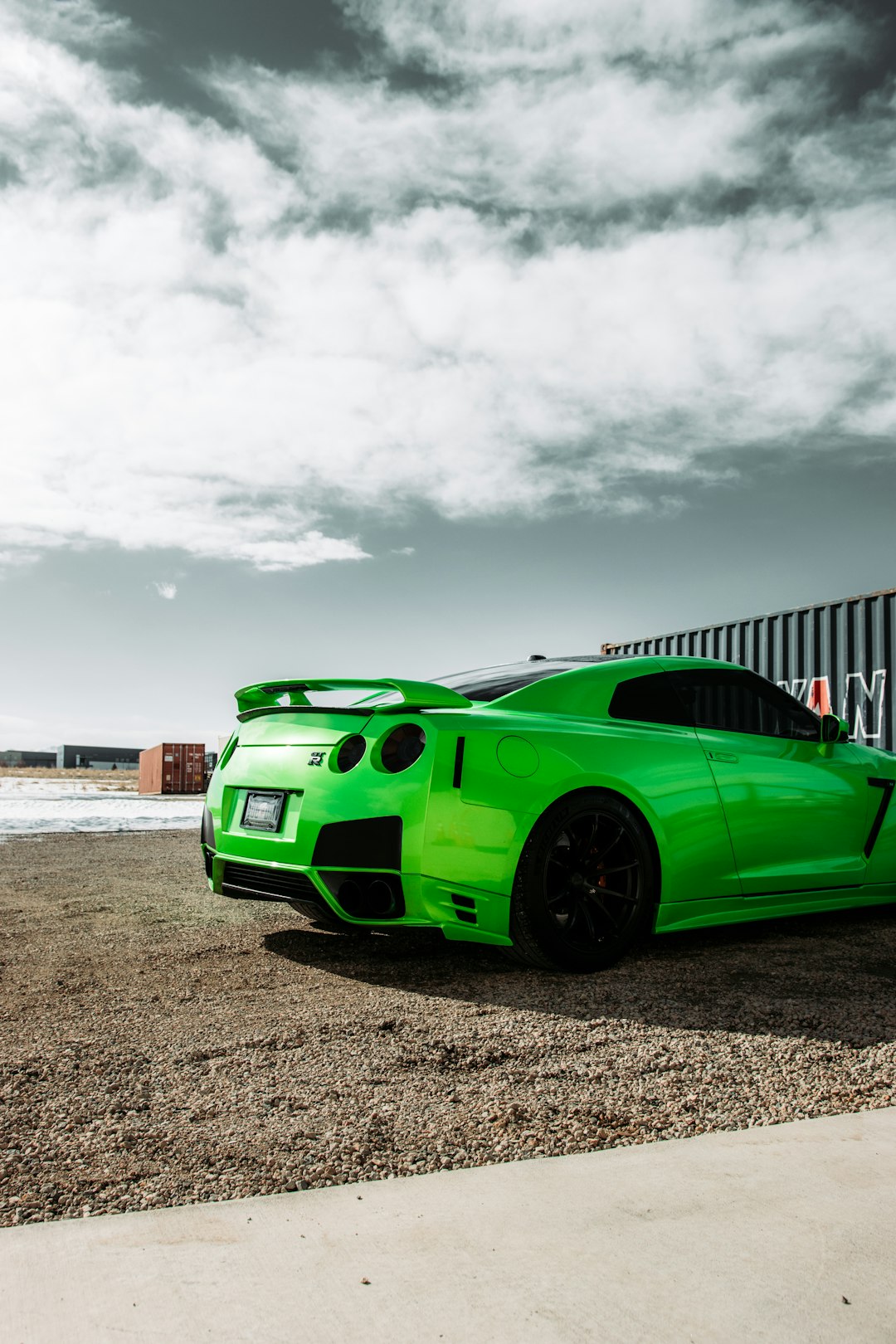 green sports car on beach during daytime