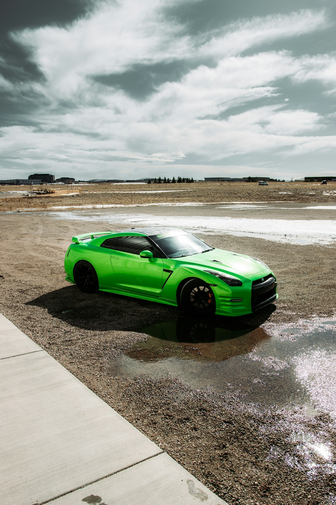 green coupe on gray concrete road during daytime