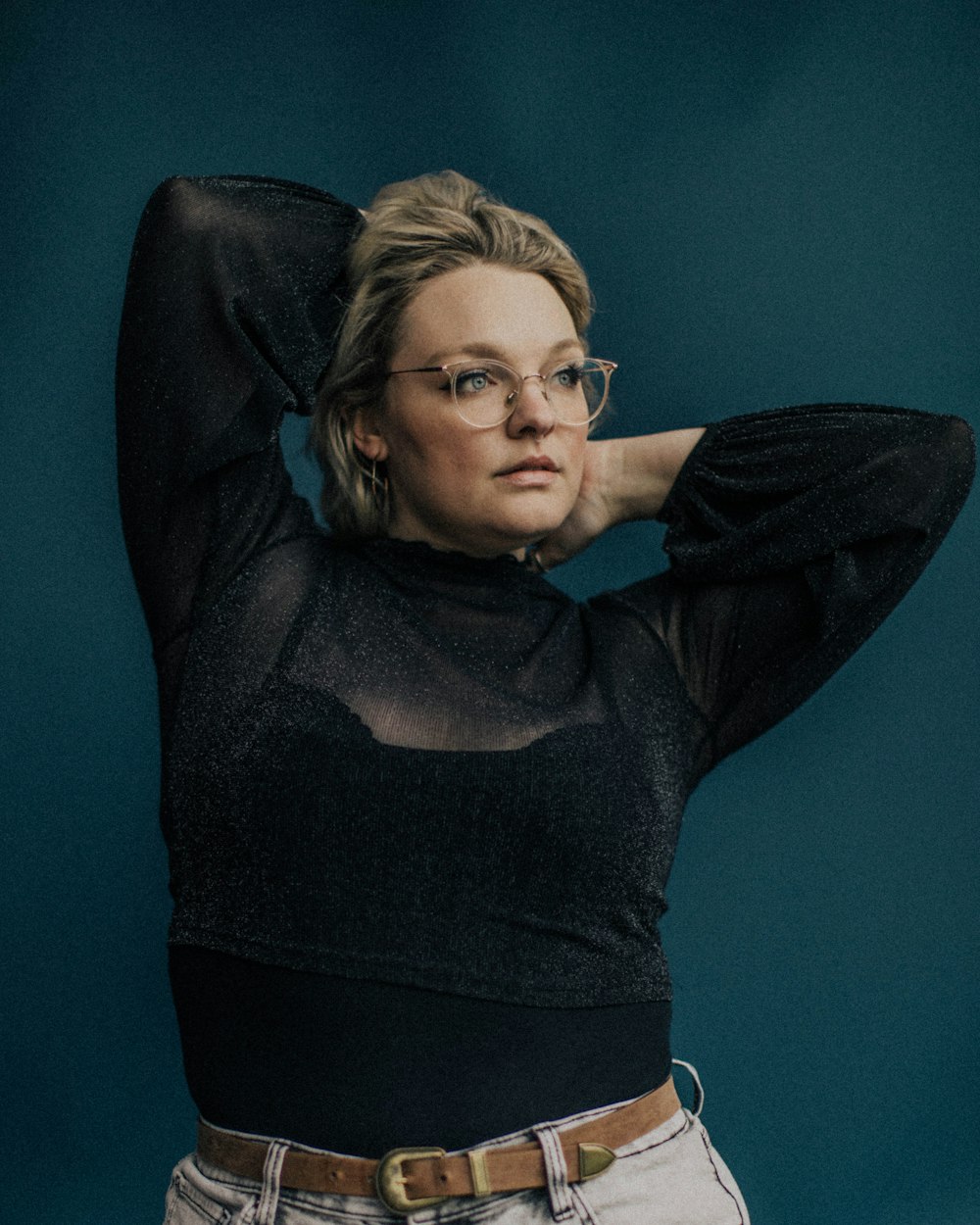 woman in black long sleeve shirt wearing eyeglasses