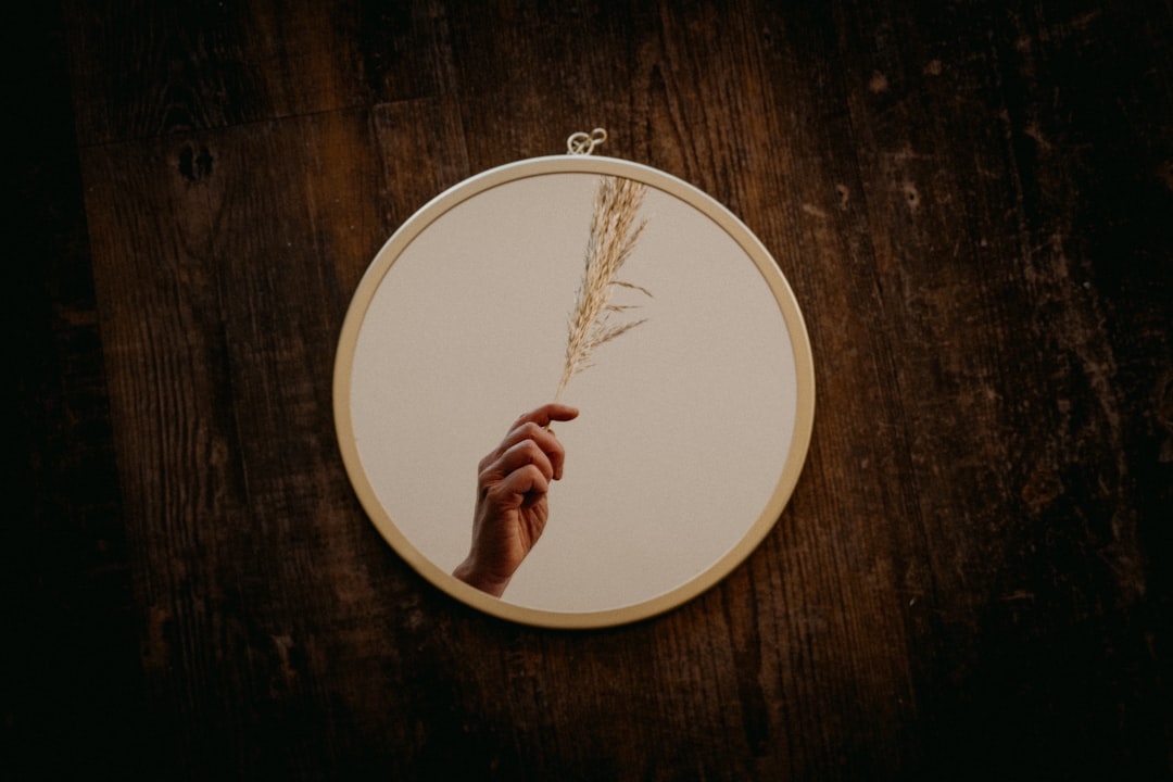 person holding round white and brown wooden round board