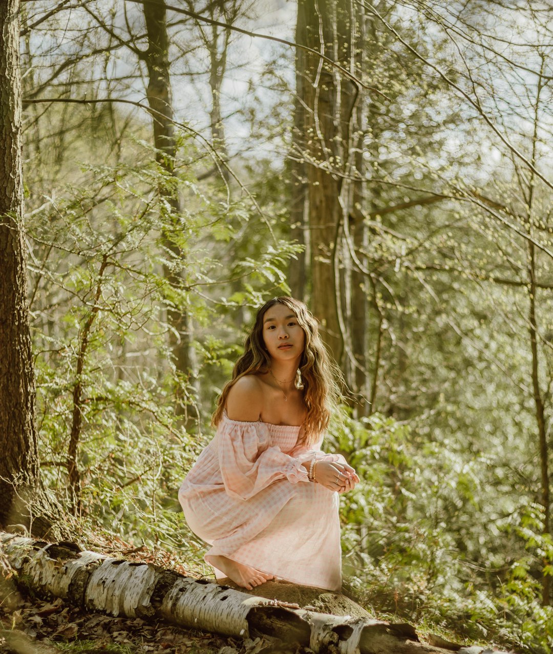 woman in white dress standing in forest during daytime
