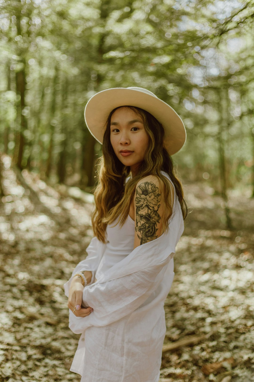 woman in white long sleeve shirt wearing brown hat