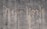 The words 'New York' are written on a textured concrete wall. The text appears to be created by a cleaning method that leaves a cleaner area in the shape of the words against the dirtier surface of the wall.