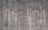 The words 'New York' are written on a textured concrete wall. The text appears to be created by a cleaning method that leaves a cleaner area in the shape of the words against the dirtier surface of the wall.
