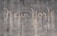 The words 'New York' are written on a textured concrete wall. The text appears to be created by a cleaning method that leaves a cleaner area in the shape of the words against the dirtier surface of the wall.