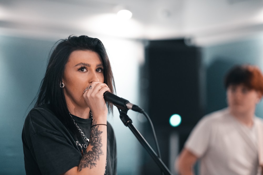 woman in black shirt singing