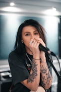 woman in black long sleeve shirt holding microphone