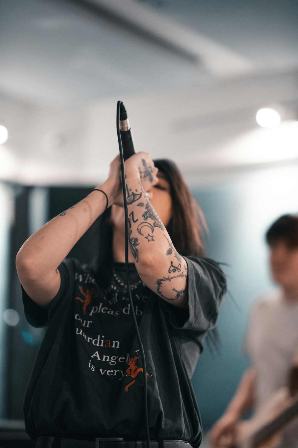 woman in black shirt holding black smartphone