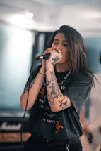 woman in black long sleeve shirt holding microphone