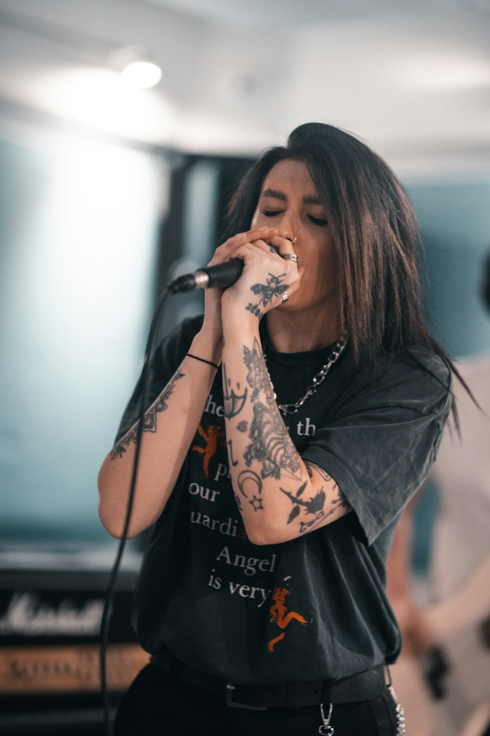 woman in black long sleeve shirt holding microphone