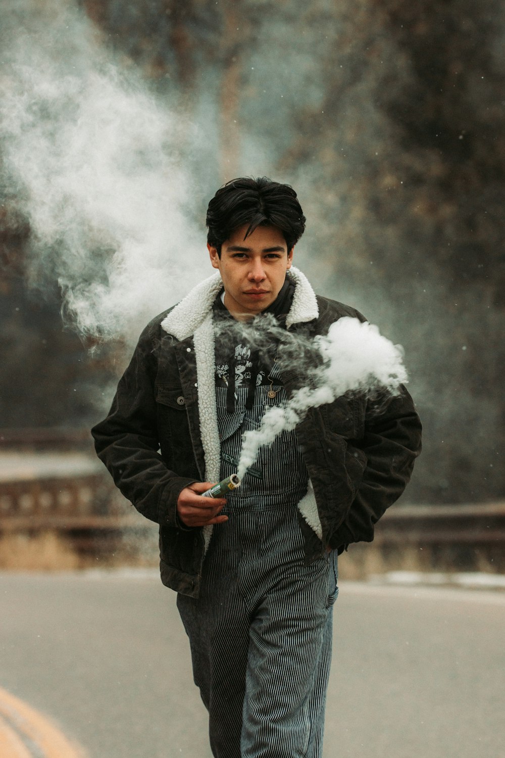 man in black leather jacket smoking