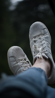 person wearing white nike sneakers