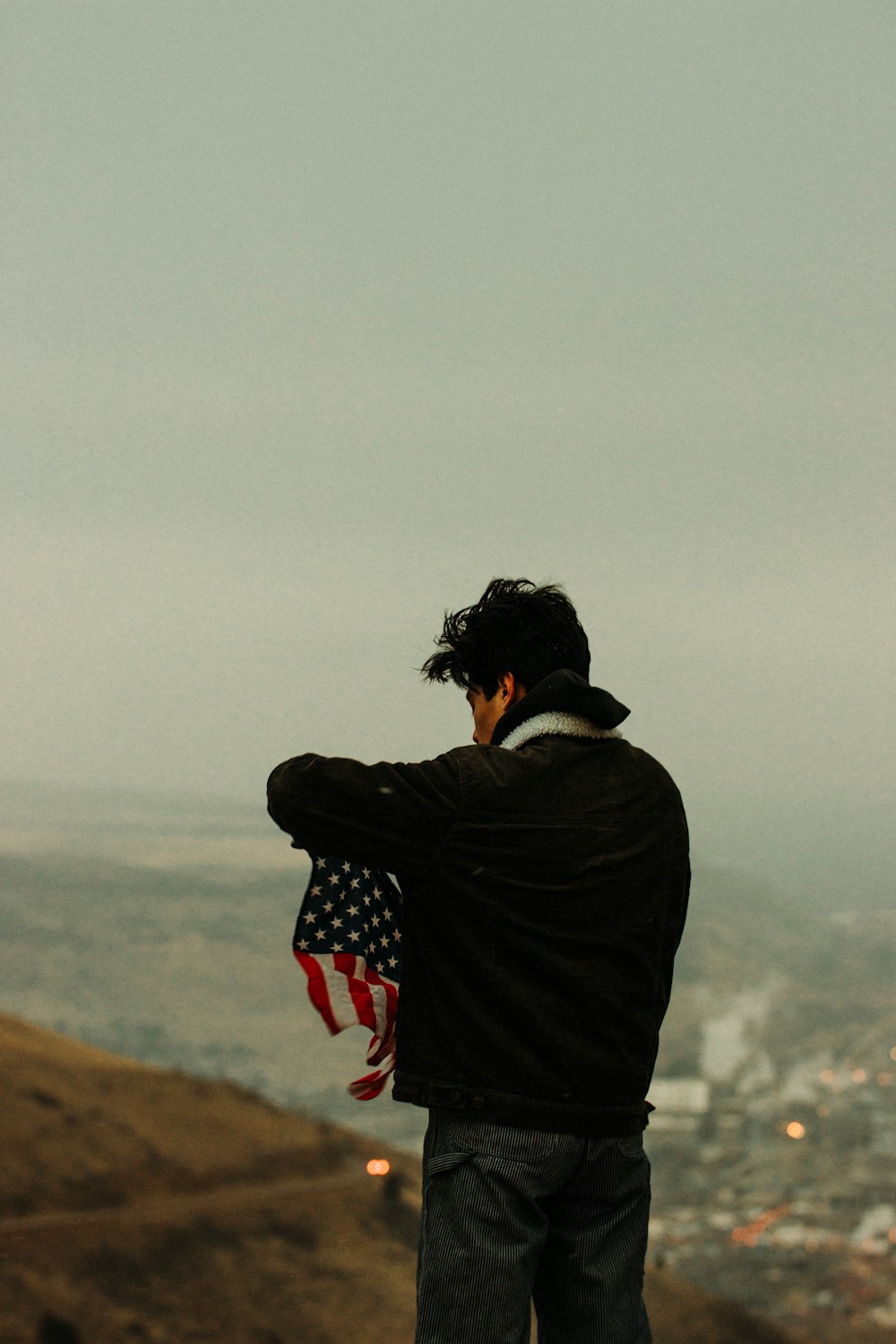 person in black jacket and red and white striped scarf