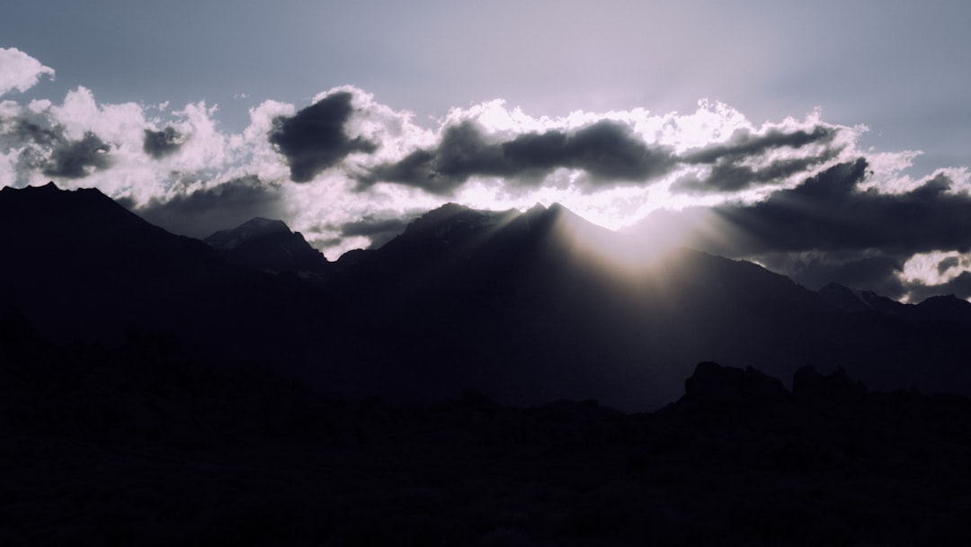 mountain range under white clouds