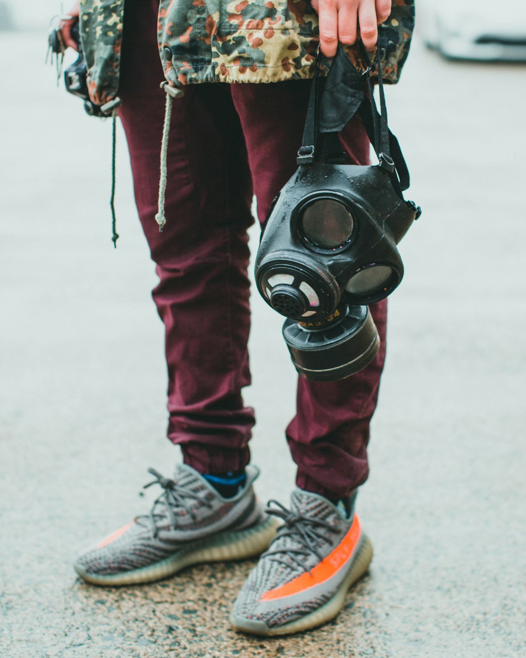 person in red pants wearing black gas mask