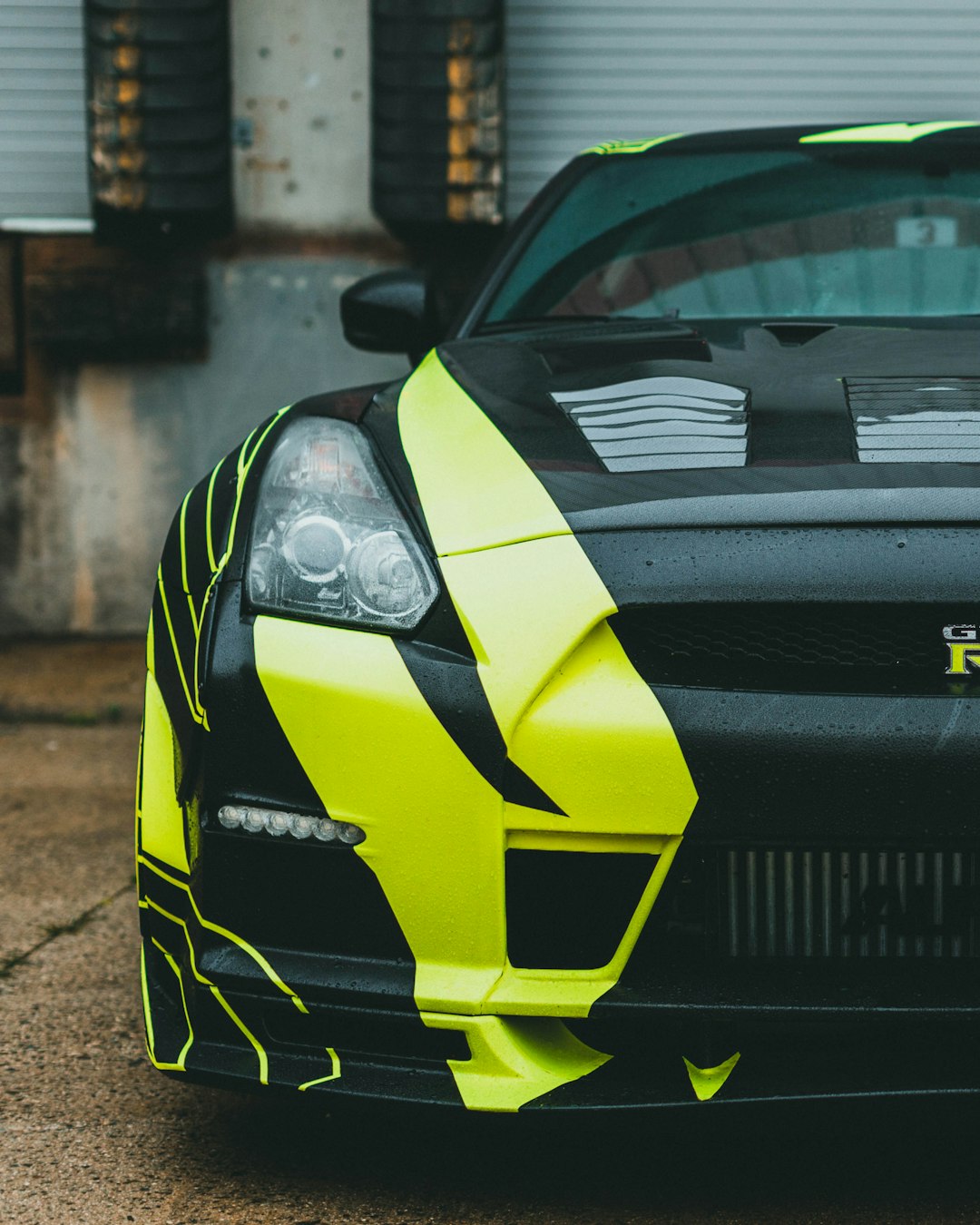 black and yellow lamborghini aventador parked near white building during daytime