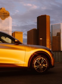 yellow car near brown concrete building during daytime